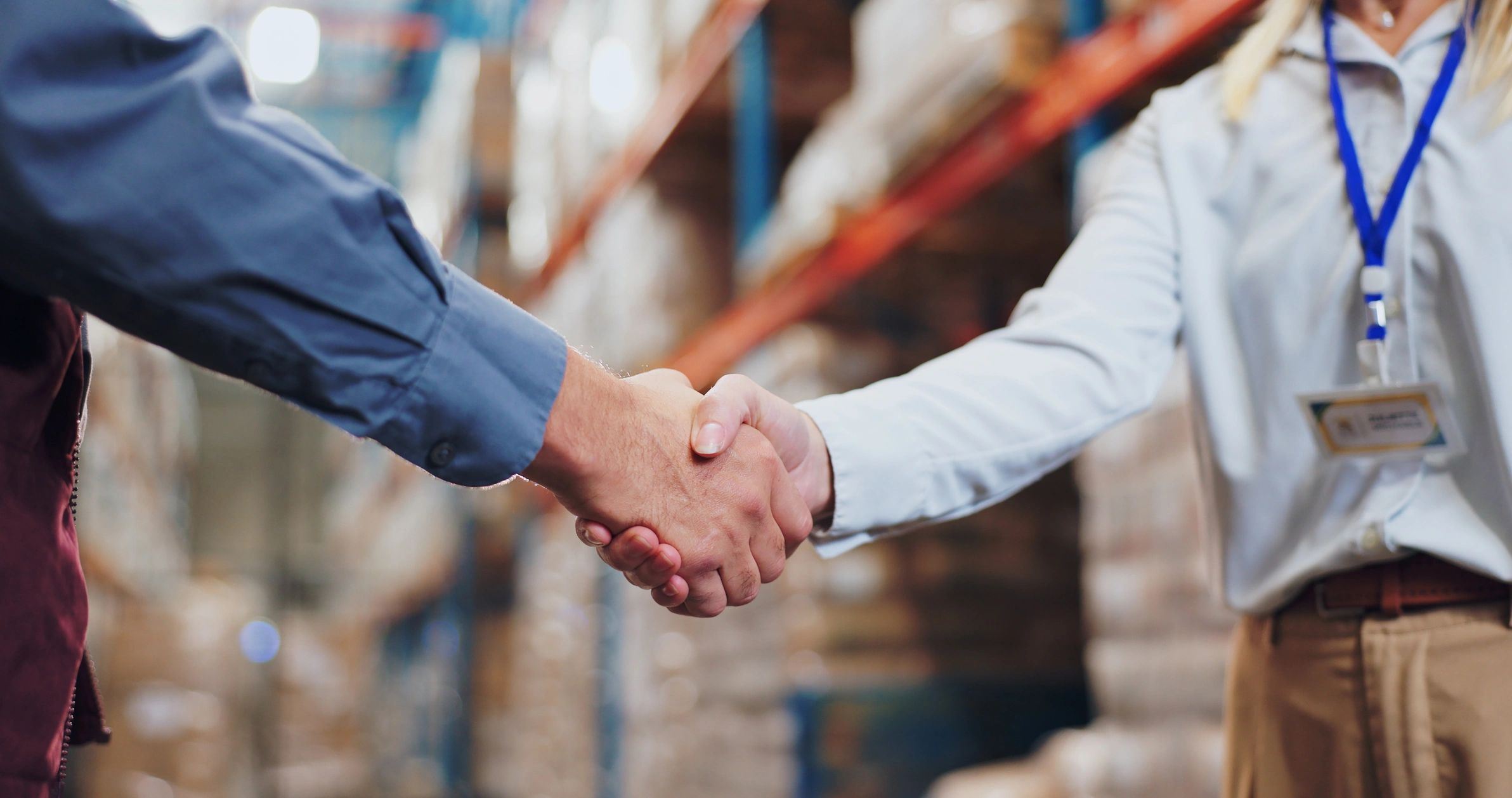 Partners shaking hands in a warehouse